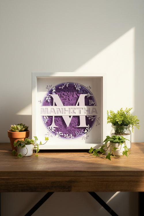 Framed paper cutout with decorative text and design on a neutral background